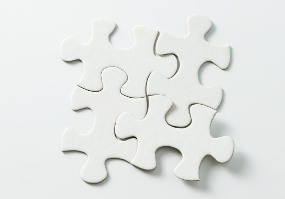 Four pieces of blank white jigsaw puzzle isolated on white background for business conceptual
